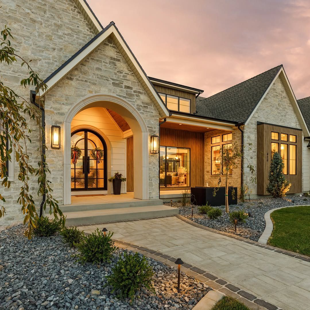 11 Around House Landscaping Ideas for Foundation to Fence 4 Small accent trees and shrubs planted in grey gravel beds near a modern stone house.