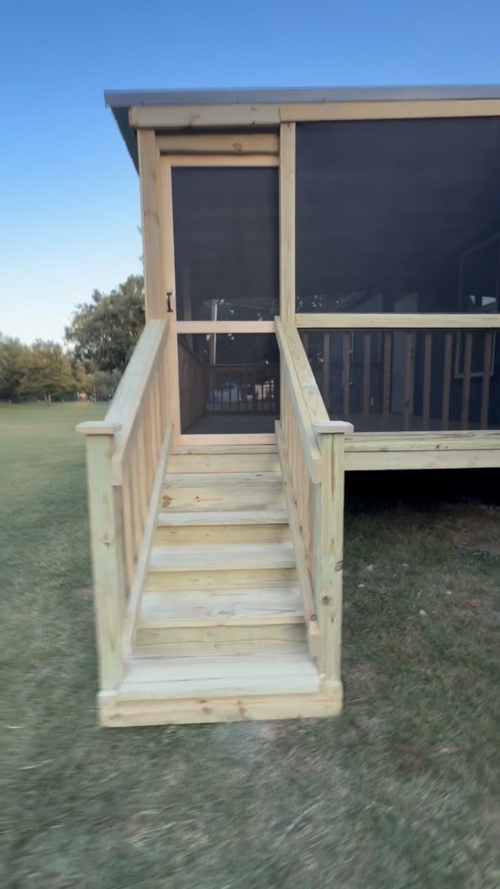 21 Backyard Deck Ideas For Any Size Space 13 A light wood screened-in deck with stairs leading up to a mesh porch area.