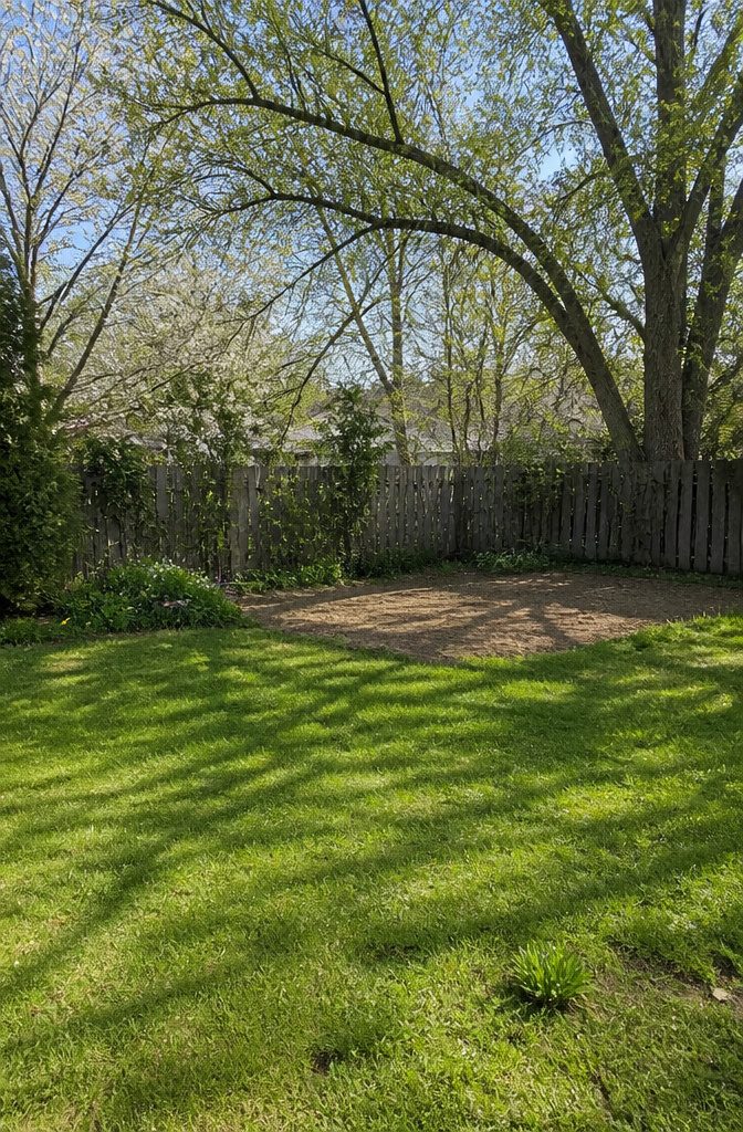 A flat spot in a yard showing potential for a vegetable garden.