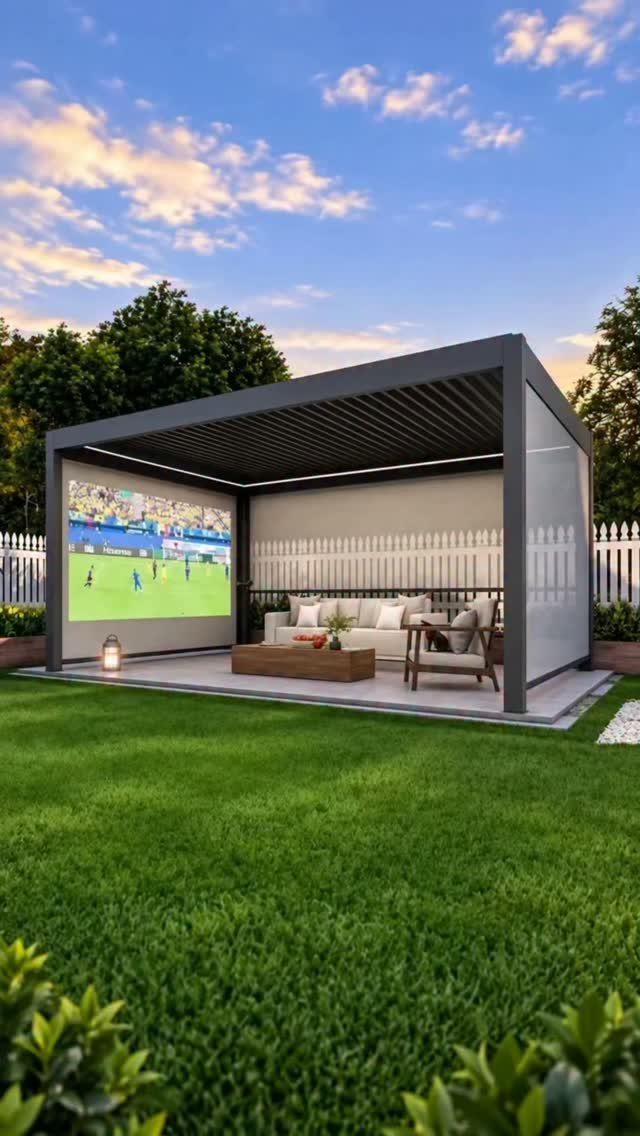 Modern dark grey gazebo featuring an outdoor movie setup on a green lawn at dusk.