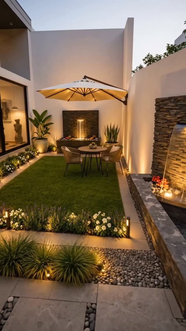 16 Beautiful Backyard Ideas for Cozy to Elegant Outdoor Spaces 5 A small outdoor dining set with an umbrella situated on a green lawn in a modern courtyard.