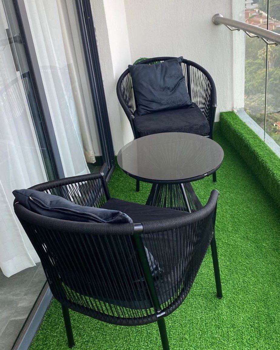 12 Deck Furniture Ideas: Layouts for Seating, Dining & Entertaining 1 Black woven bistro set with two chairs and a round table on green turf.