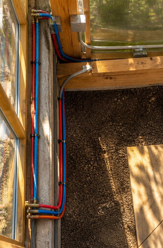 Water and electrical lines connecting to a greenhouse.