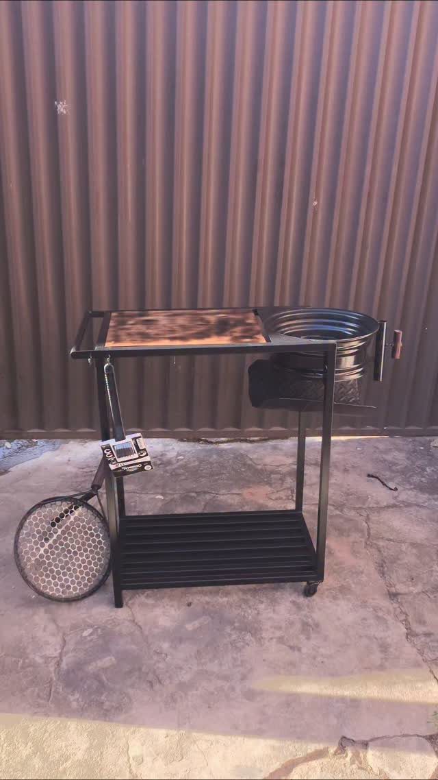 Pallet Grill Station: 7 Outdoor Builds from Cart to Kitchen 2 Black metal rolling barbecue cart with a wooden top and circular grill basin on wheels.
